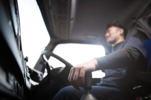 Male hand driving a truck