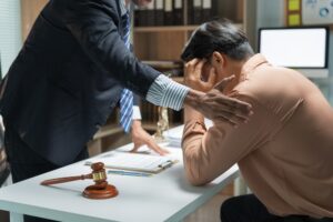 Lawyer comforting a distressed client after delivering disappointing news about the ongoing case