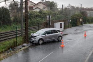 Impactful collision Car crashes into pole on a cold, rainy winter morning
